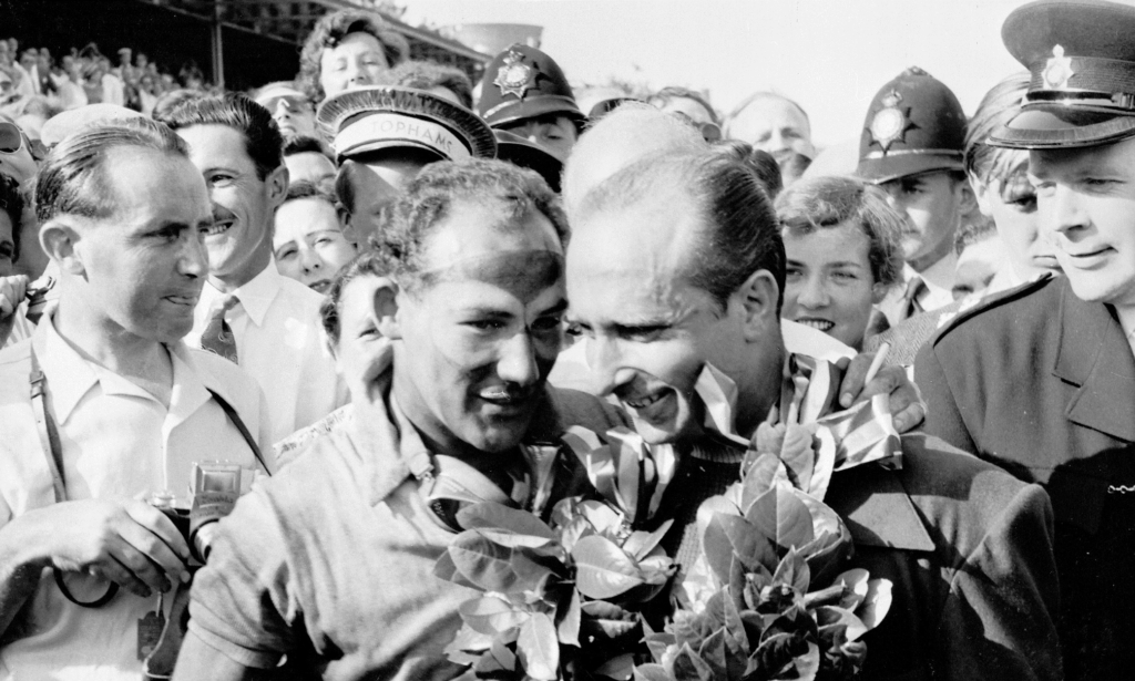 1955 British Grand Prix winner Moss and runner-up Juan Manuel Fangio on the winners’ podium.