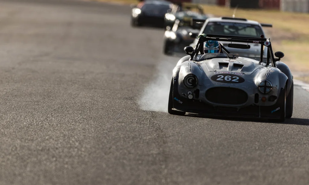 A smokey entry, as the Pesty Racing Backdraft roadster locks the wheels on braking into turn 4 at Killarney