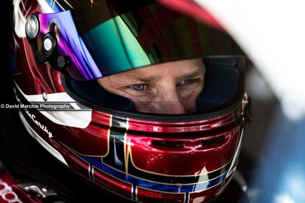 Concentration - capturing the moment of intense focus on a drivers face is tremendous, and having the narrow depth of field, leading ones eye to the focus and clarity of his eye makes this a beautiful image for me.