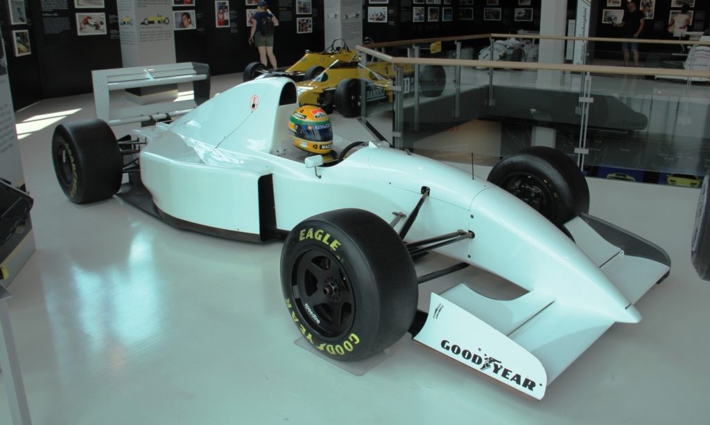 A Lamboghini powered F1 car with a famous helmet in the cockpit