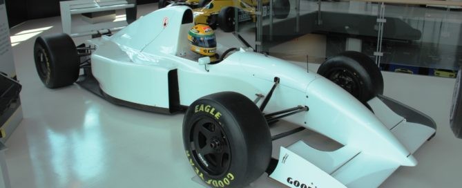 A Lamboghini powered F1 car with a famous helmet in the cockpit