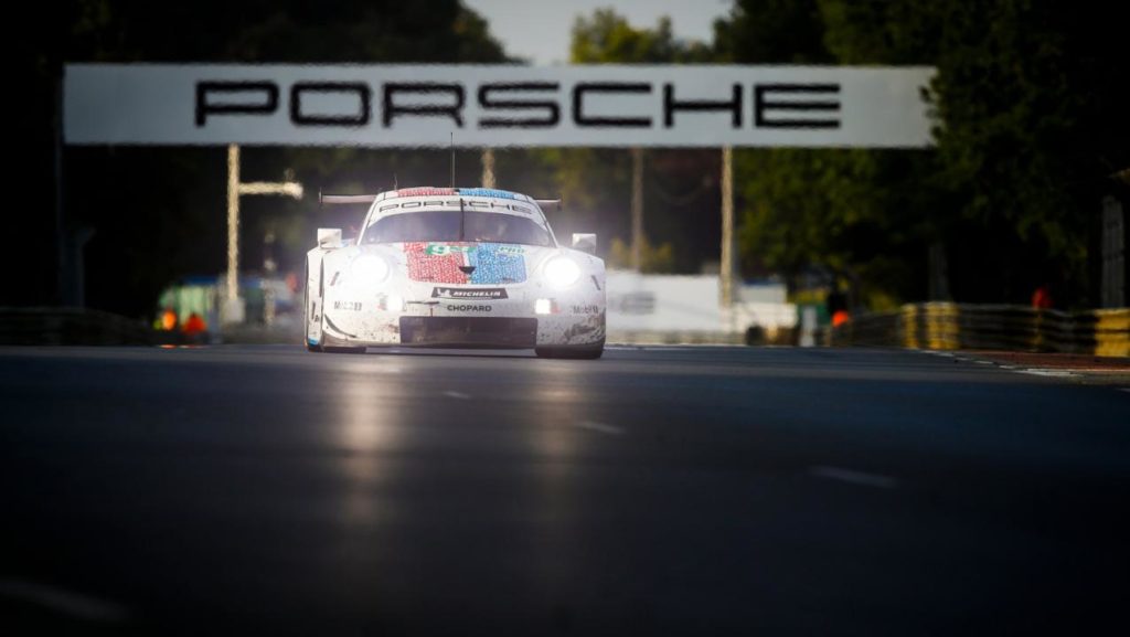 A Porsche 911 RSR tackles the Porsche Curves at dusk in the 2019 Le Mans