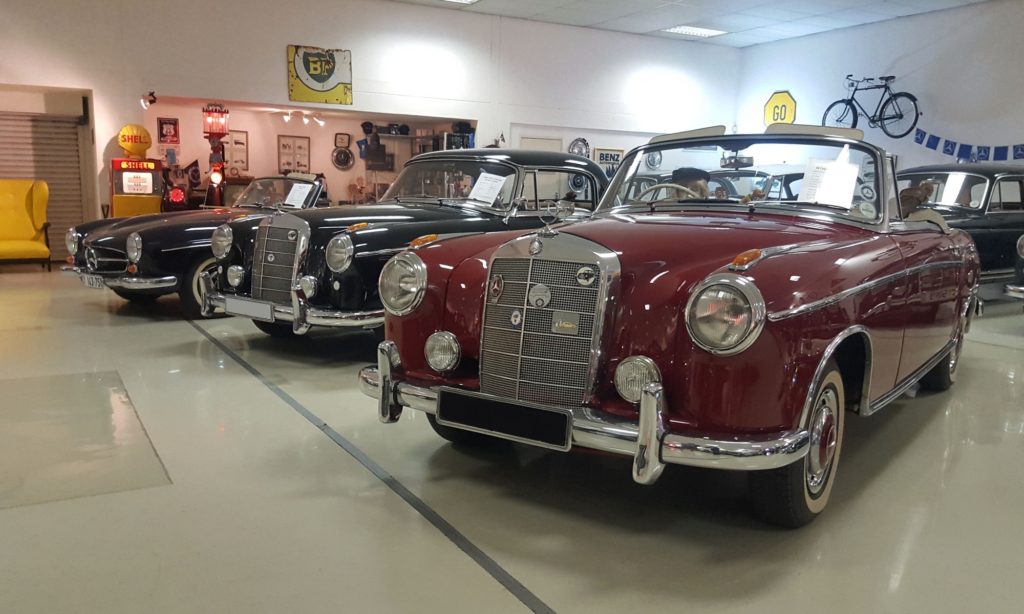 A stunning drop-top Ponton in the foreground with a 190SL in the background.