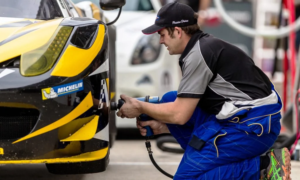 His cap says it all, to work in the pit crew of a race team you have to be passion driven.