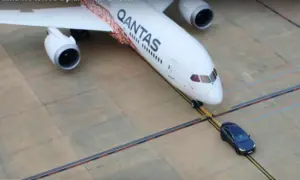 Tesla tows a Qantas plane