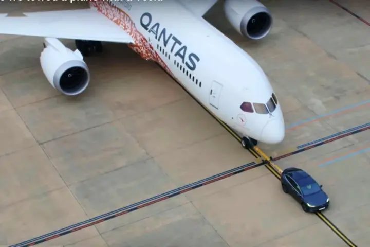 Tesla tows a Qantas plane
