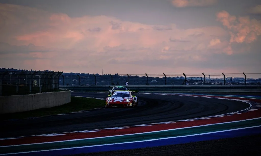 The Porsche 911 GT3 R through the famous Sunset corner at sunset during Friday practice